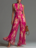 Mono fucsia de gasa con estampado floral, sin mangas, cremallera, plisado y pierna ancha