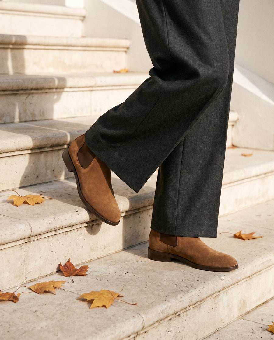 Brown suede chelsea boots on stone steps